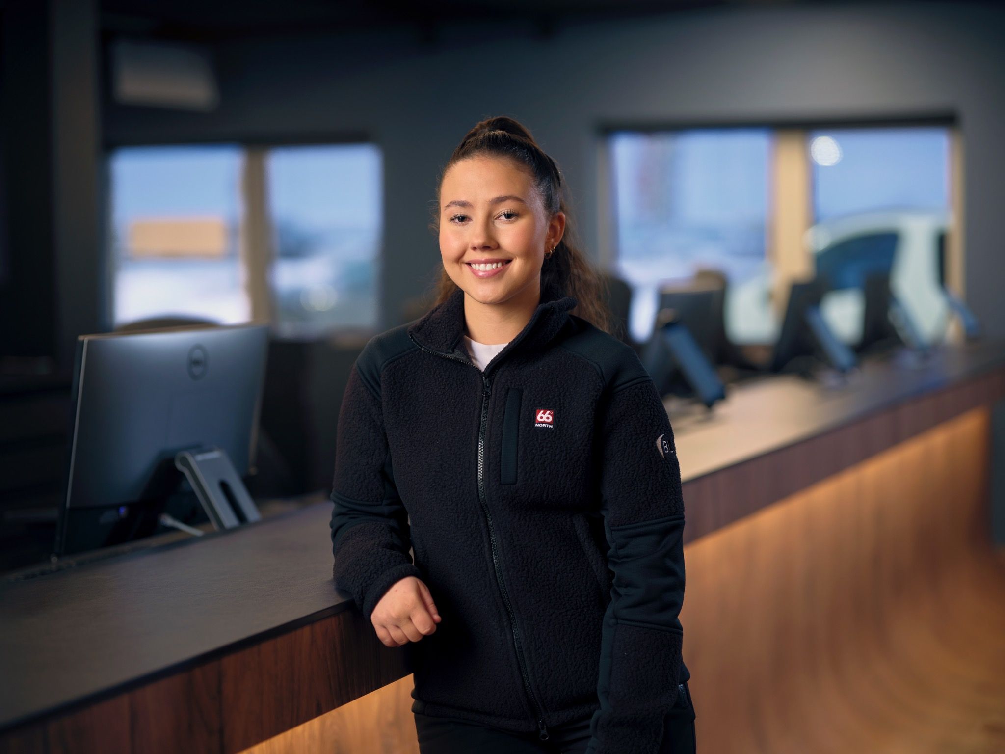 Woman in leading car rental in Iceland for car key collection at Airport