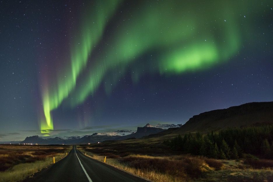 Northern lights on a road at Snaefellsnes peninsula iceland.