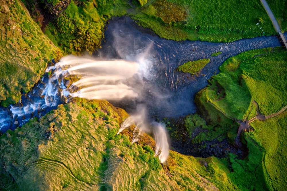 Aerial view of Seljalandsfoss waterfall in South Iceland with surrounding green landscape”