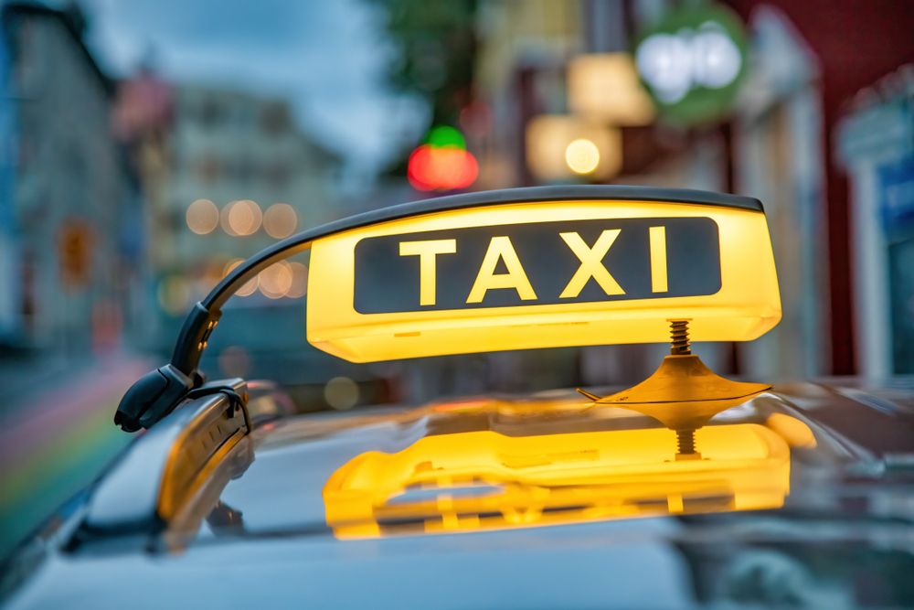 Taxi sign glowing at night in downtown Reykjavík