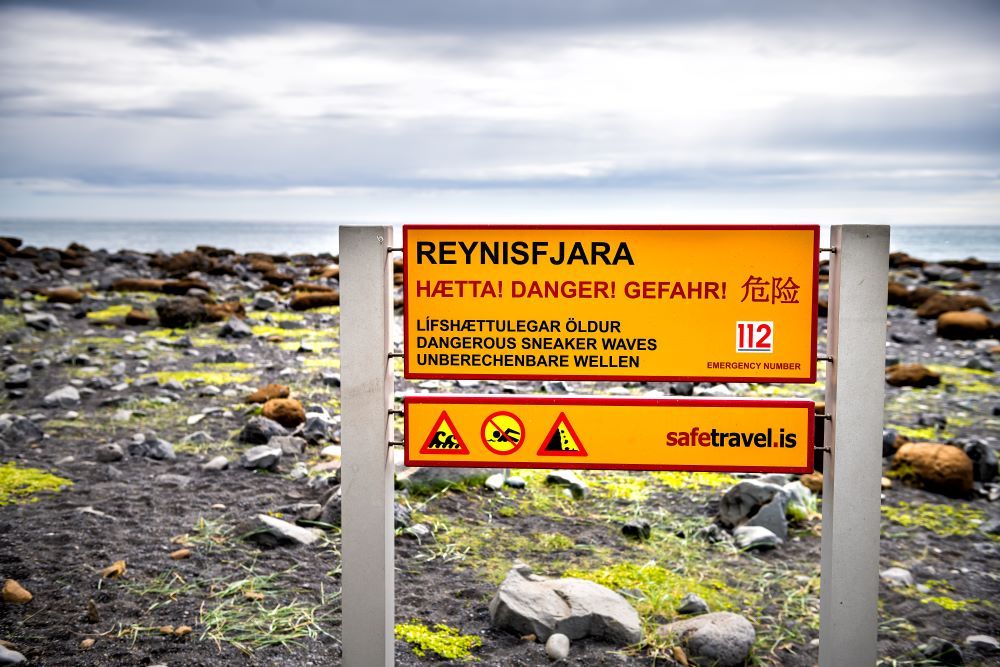 Warning signs at Reynisfjara black sand beach.