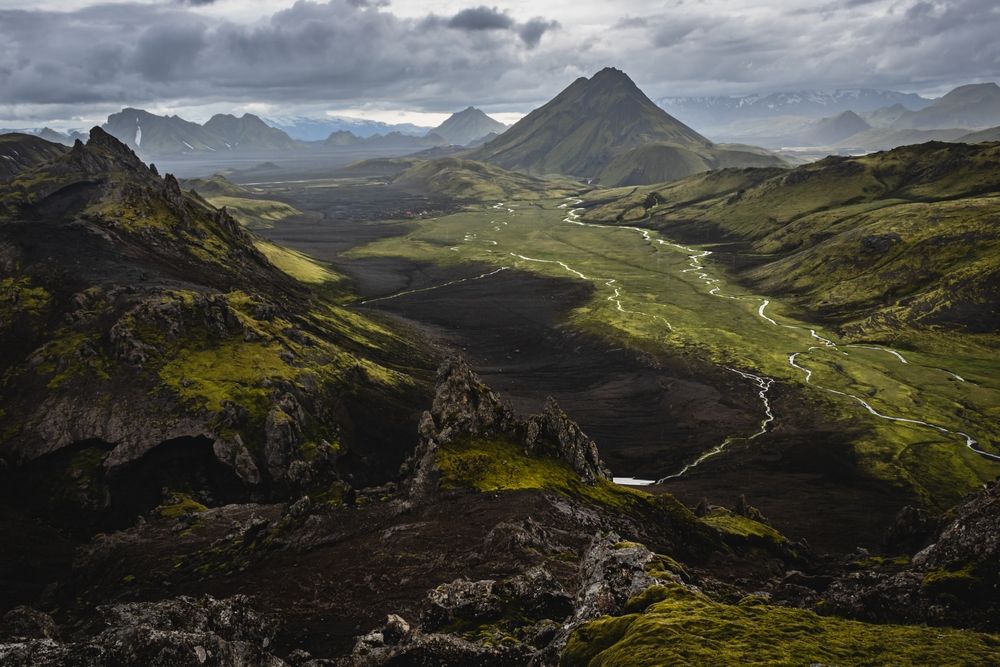 Mossy volcanic highland valley in Iceland with winding rivers and peaks