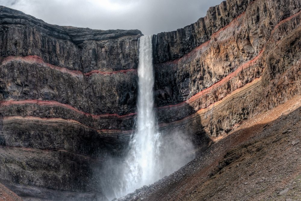 Dynjandi waterfall cascading down terraced rock layers in the Westfjords of Iceland.