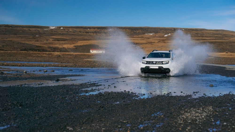 4x4 Dacia Duster crossing a river on an F-road in Iceland
