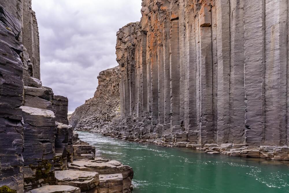 Pillar rocks and green river at Stuðlagil Canyon Iceland